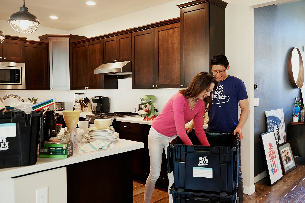 couple decluttering in the kitchen